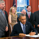 President Barack Obama signs the School Access to Emergency Epinephrine Act (H.R. 2094) in the Oval Office of the White House on November 13, 2013 (Photo by Kristoffer Tripplaar-Pool/Getty Images)